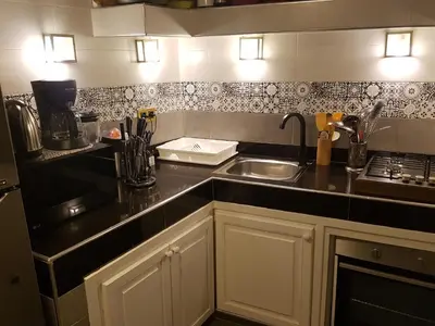 a kitchen with a sink and a counter top at Riad BILKIS in Marrakech