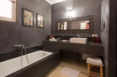 a bathroom with a bath tub and a sink at Riad Alegria in Marrakech
