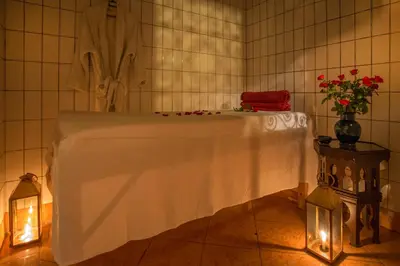 a table with a white table cloth in a room at Riad Jnane Mogador in Marrakech