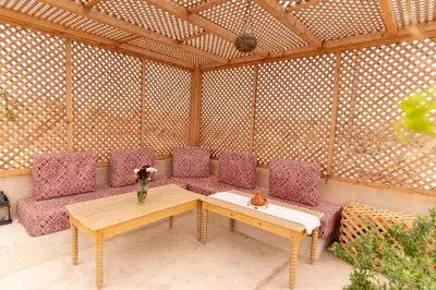 a room with a table and chairs in a pergola at Riad Shambala in Marrakech