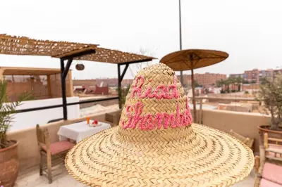 a straw hat sitting on top of a table at Riad Shambala in Marrakech