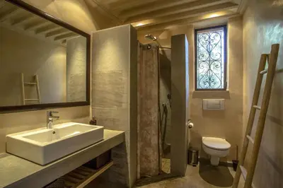 a bathroom with a sink and a toilet and a window at Villa Atlas de Luxe avec piscine privée Domaine des Kasbahs in Marrakech