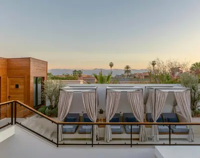 a room with a table and chairs on a balcony at La Brillante Marrakech in Marrakech