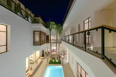 an indoor pool in the middle of a building at La Brillante Marrakech in Marrakech
