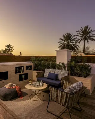 a patio with a couch and chairs and a table at La Brillante Marrakech in Marrakech