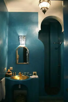 a blue bathroom with a sink and a mirror at Riad Dar Zampa in Marrakech