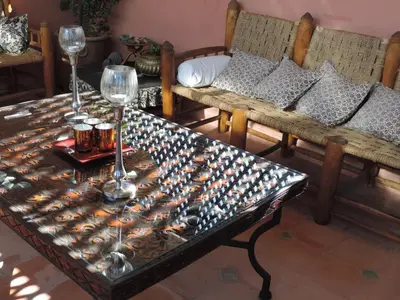 a table with wine glasses on top of it at Riad Dar Zampa in Marrakech