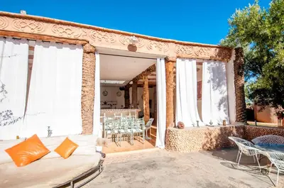 a patio with a couch and a table and chairs at SA FONDA in Tameslouht