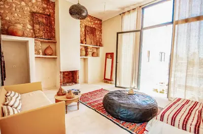 a living room with a large ottoman on the floor at SA FONDA in Tameslouht