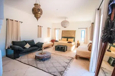 a living room with a couch and a bed at SA FONDA in Tameslouht