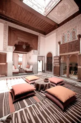 a large room with four beds in a room with at Ryad El Borj in Marrakech