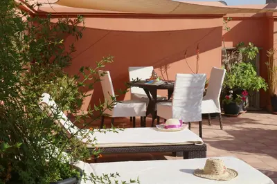 a patio with a table and chairs under a tent at Ryad El Borj in Marrakech