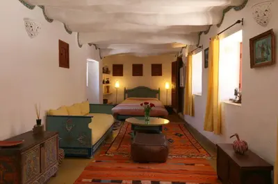 a bedroom with a bed and a table in a room at Ryad El Borj in Marrakech