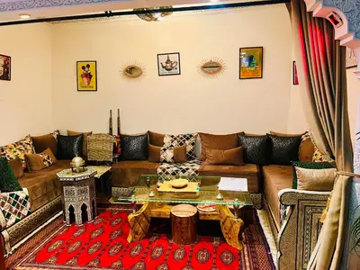 a living room with a couch and a table at Riad Maison Aicha in Marrakech