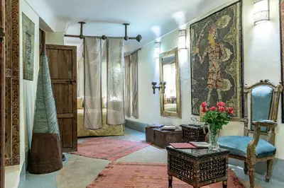 a living room with a vase of flowers on a table at Riad du Ciel Marrakech in Marrakech