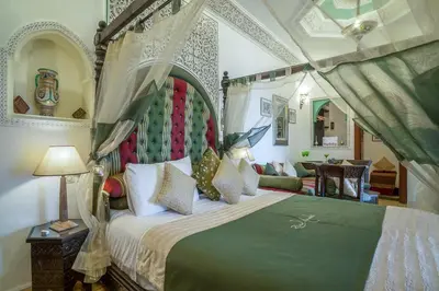 a bedroom with a large bed with a canopy at Riad Anabel in Marrakech