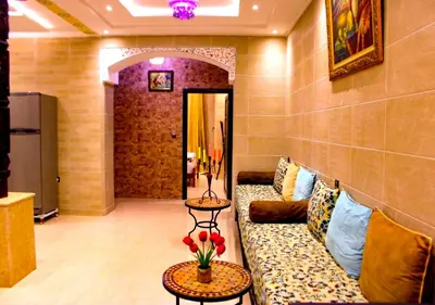 a living room with a couch and two tables at Miramare Marrakech in Marrakech
