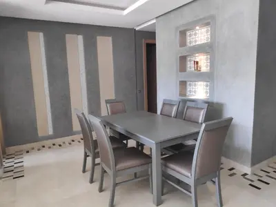 a dining room with a table and chairs at Magnifique appart vue sur golf in Marrakech