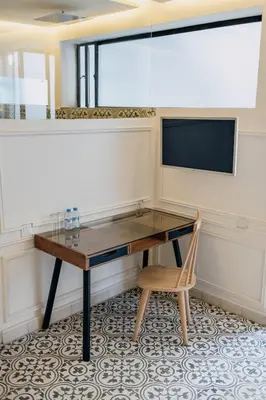 a desk in a room with a tv and a chair at Riad Aïcha Kitchen in Marrakech