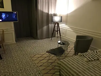 a room with a bed and a lamp and a television at Riad Aïcha Kitchen in Marrakech