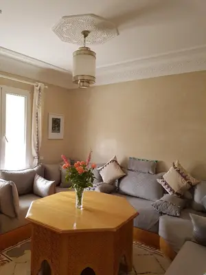 a living room with a couch and a table at Riad Espressino exclusive Marrakech in Marrakech