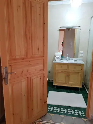 a bathroom with a wooden door and a sink at Riad Espressino exclusive Marrakech in Marrakech