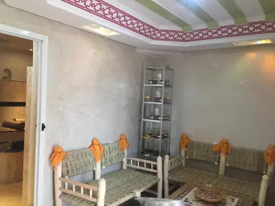 a dining room with chairs and a shelf in a room at Riad Mahjouba Marrakech & SPA in Marrakech