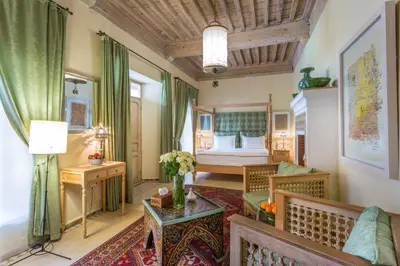 a hotel room with a bed and a table at Riad Azoulay in Marrakech