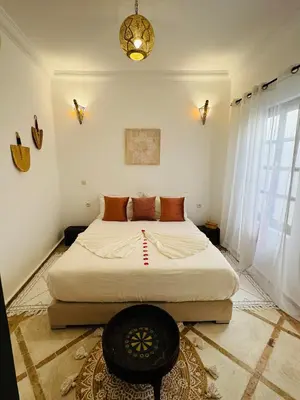 a bedroom with a large bed in a room at Riad Bjoujna in Marrakech