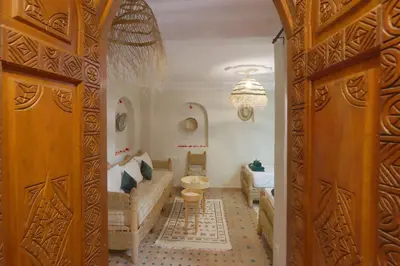 a living room with a couch and a table at Riad Venezia in Marrakech