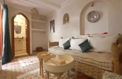a living room with a couch and a table at Riad Venezia in Marrakech
