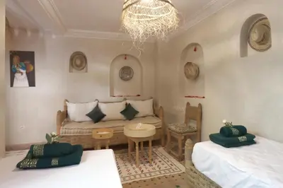 a living room with two beds and a couch at Riad Venezia in Marrakech