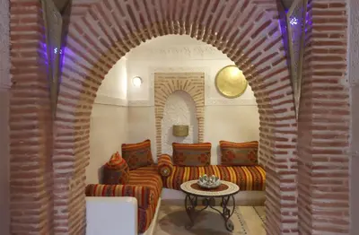 a living room with two couches and a table at Riad Venezia in Marrakech