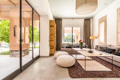 a living room with a couch and a table at Zagora and Marhba villas Marrakech - by EMERALD STAY in Marrakech