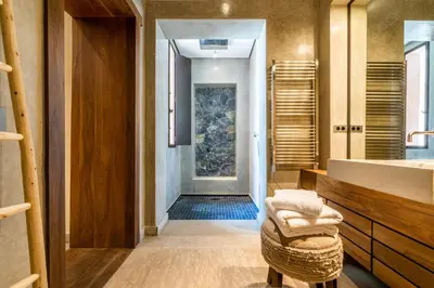 a bathroom with a sink and a mirror and a hallway at Zagora and Marhba villas Marrakech - by EMERALD STAY in Marrakech
