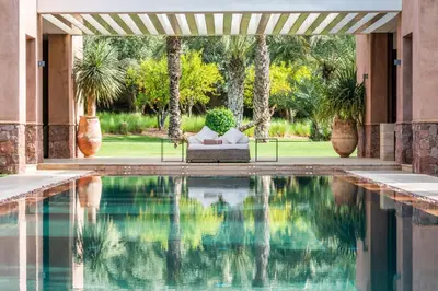 a swimming pool in front of a house with a patio at Zagora and Marhba villas Marrakech - by EMERALD STAY in Marrakech