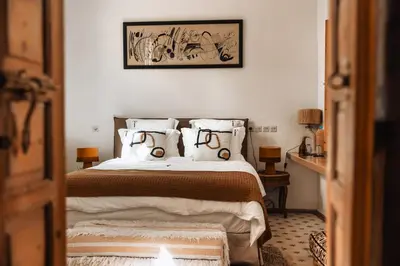 a bedroom with a bed and a picture on the wall at Riad Instant T in Marrakech