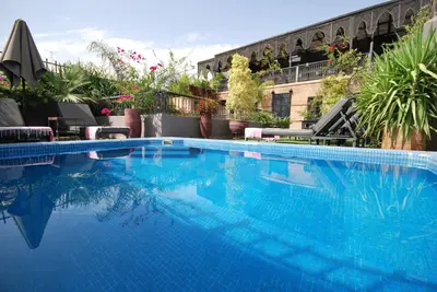 a large blue swimming pool on top of a building at Riad Terra Bahia in Marrakech