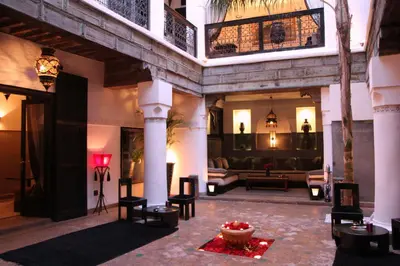 a living room with a couch and a table at Riad Terra Bahia in Marrakech