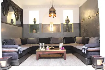 a living room with a couch and a table at Riad Terra Bahia in Marrakech