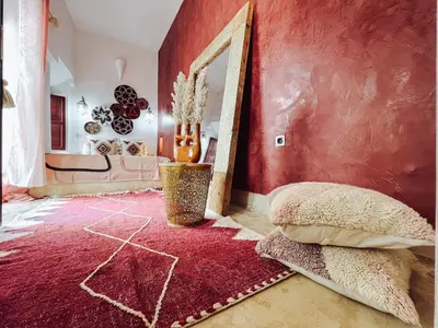 a red room with a mirror and a red wall at DAR AURORA in Marrakech