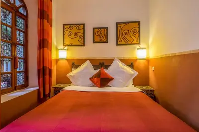a bedroom with a bed with two pillows on it at Riad Sable Chaud in Marrakech