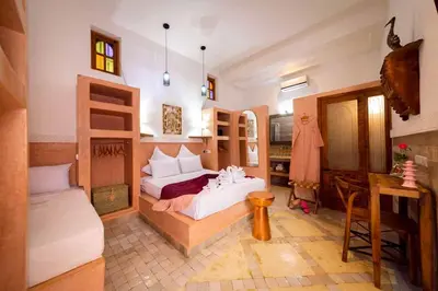 a bedroom with two bunk beds and a table at Riad Ambre et Jasmin in Marrakech