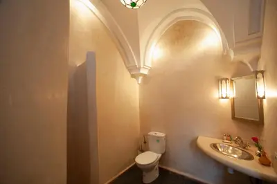a bathroom with a toilet and a sink at Riad des trois palais in Marrakech
