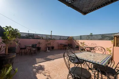a patio with a table and chairs on a patio at Riad Saad in Marrakech