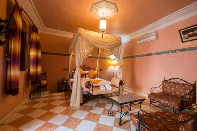 a bedroom with a bed with a canopy at Riad Saad in Marrakech