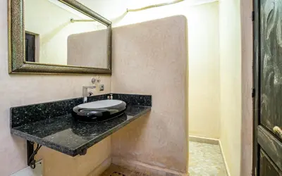 a bathroom with a sink and a mirror at Kasbah Alili in Marrakech