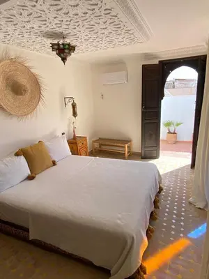 a bedroom with a large white bed in a room at Riad Casa Sophia in Marrakech