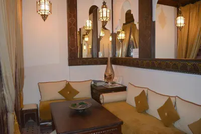 a living room with a couch and a table and a mirror at Riad Ghali Hotel & SPA in Marrakech
