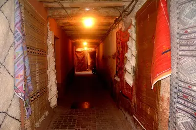 a long hallway with a light at the end of a tunnel at Riad Ghali Hotel & SPA in Marrakech